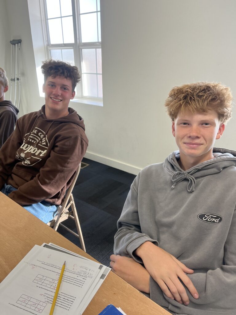 Two Pathways Christian Academy students working on classwork together in a small class in Boise, Idaho